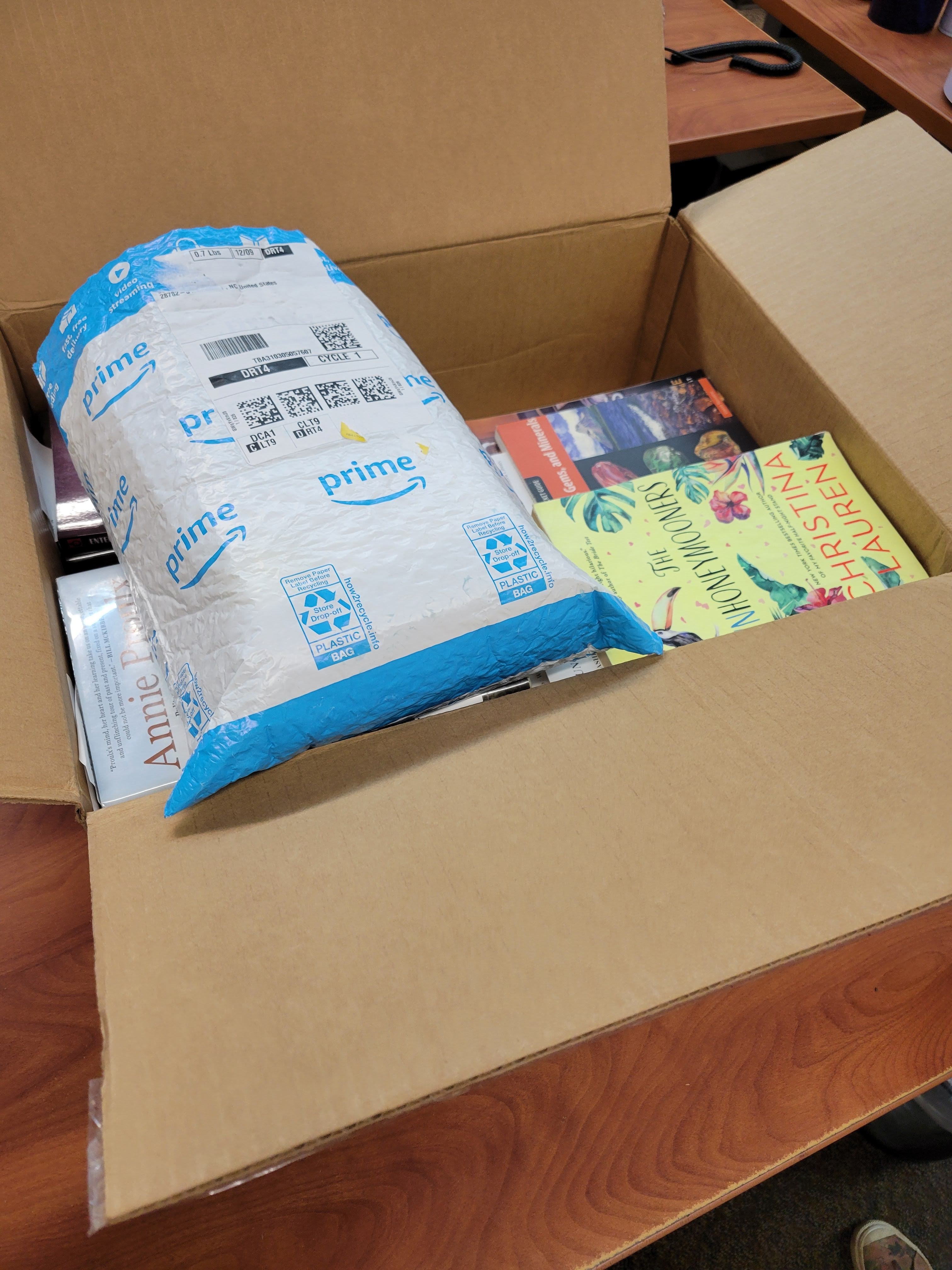 A padded envelope placed on top of materials in a box to provide cushioning.